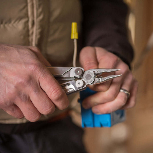 Translation missing: en.Man using Wave+ wire cutters on a wire