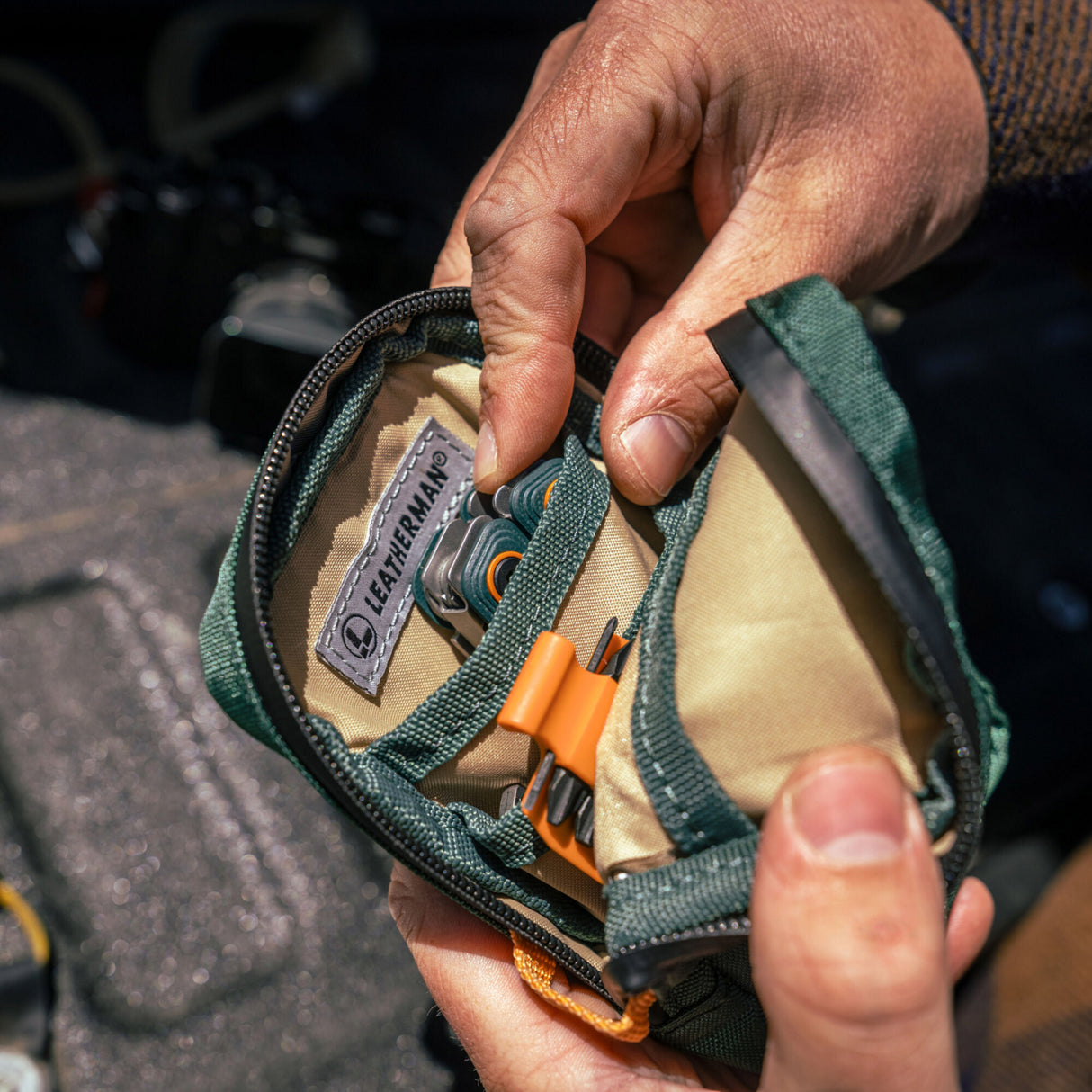 Translation missing: fr.A person holds Leatherman Hunter Tool Pouch, showcasing its compact size and practical design