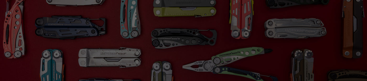 Translation missing: fr.A variety of Leatherman tools in different styles are arranged on a vibrant red surface