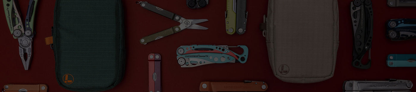 Translation missing: fr.A variety of Leatherman tools in different styles are arranged on a vibrant red surface