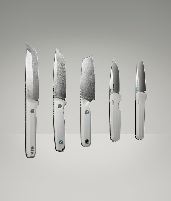 Translation missing: en.Product display image featuring five Leatherman knives in a clean, gradient-lit studio setting. The lineup includes various blade styles and handle orientations, all in a matching alpine white colorway, showcasing both profile and edge-on views to highlight the craftsmanship and design variations
