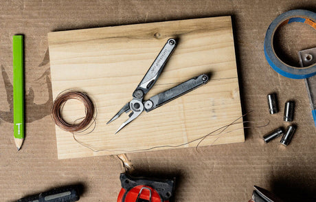 Leatherman Wave next to craft supplies on table