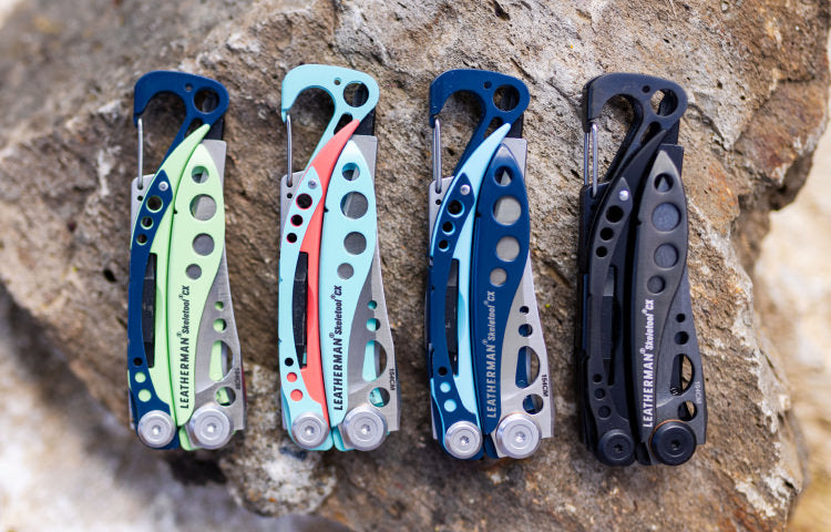 Four Skeletool CX on a rock surface, varying colors.