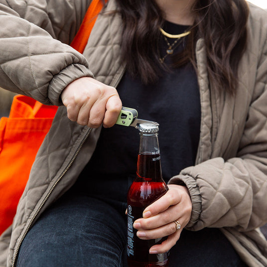 Using the bottle opener on a FREE T4 to pop the top off a glass bottle of soda