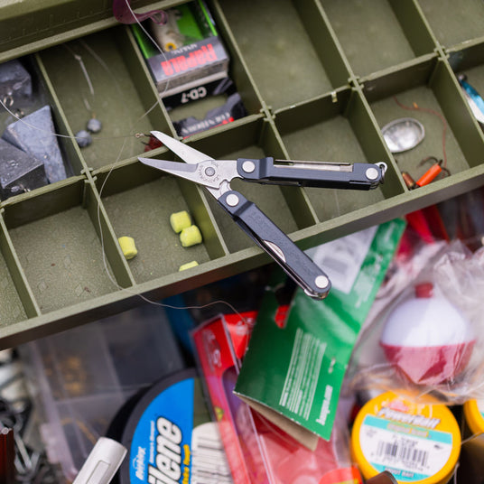 Tackle box open with an opened Micra laying on top