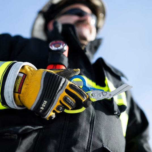 Firefighter with gloves holding an open Raptor Rescue