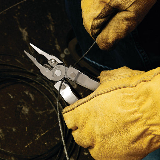 Someone wearing gloves using Rebar wire cutters to cut a wire