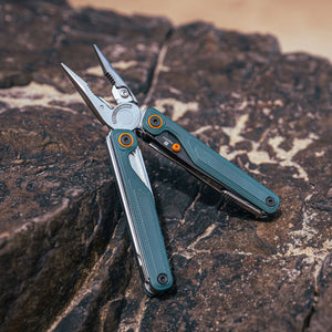 Translation missing: en.Cascadia Leatherman Wave® Alpha multi-tool opened on a rock surface, showcasing its sleek design and pliers