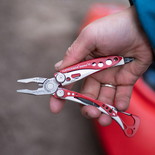 Person holding an open Skeletool RX with pliers partially opened