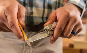 Translation missing: en.Man using knife blade on Leatherman Curl to sharpen yellow pencil