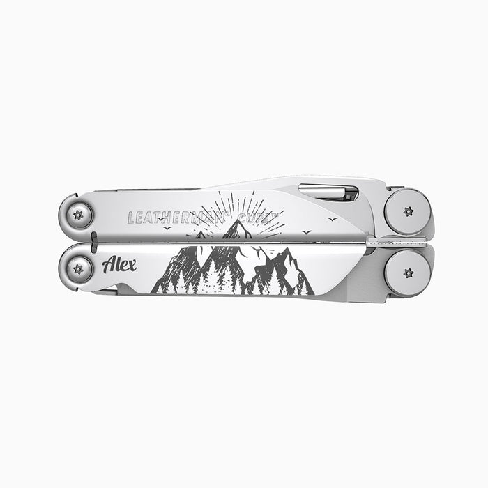 Translation missing: fr.A stainless steel Leatherman Curl multitool featuring a detailed engraving of a mountain landscape with radiating lines suggesting a sunrise or sunset behind the mountains. The name “Alex” is engraved on one side