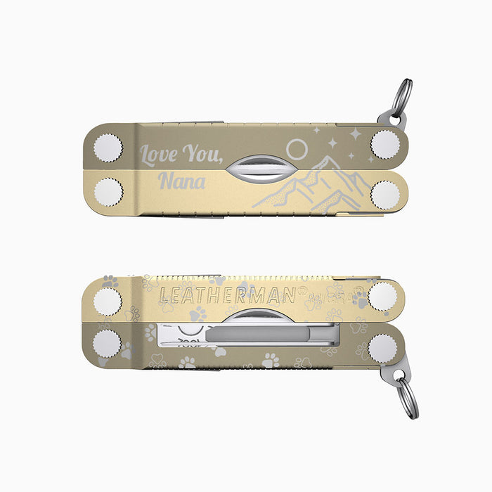 Translation missing: fr.A two-tone cappuccino-colored Leatherman Micra multitool engraved with mountains, pawprints, stars, and the message “Love You, Nana.”
