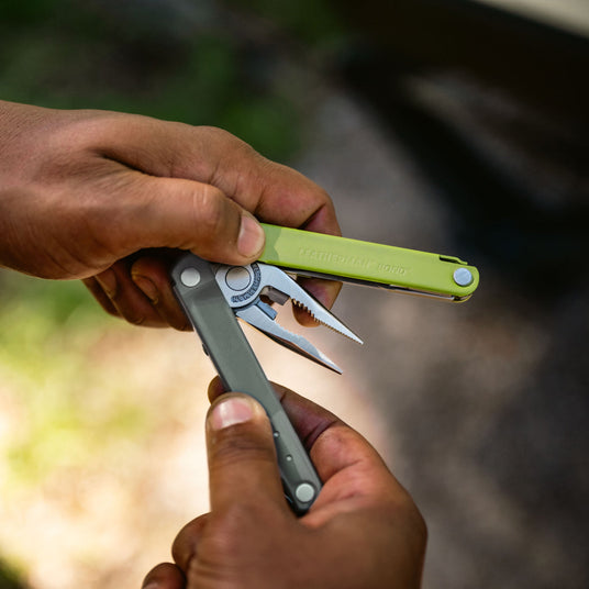 Person holding Mossy Slate Bond partially open showing pliers.