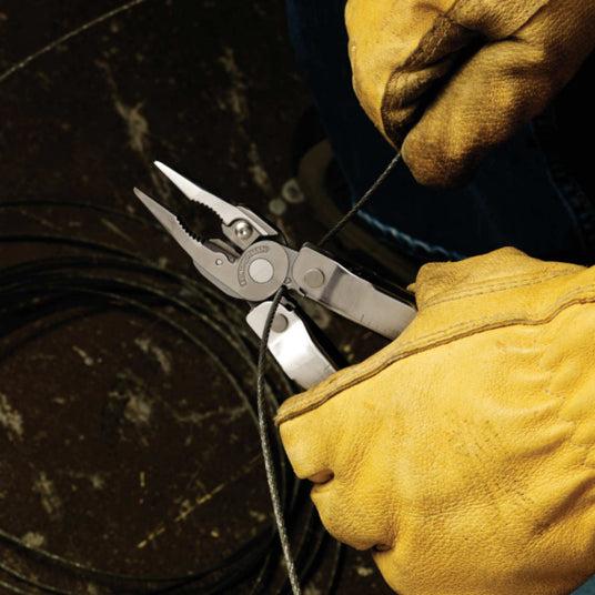 Person wearing gloves using a Super Tool 300 wire cutter to cut a wire.