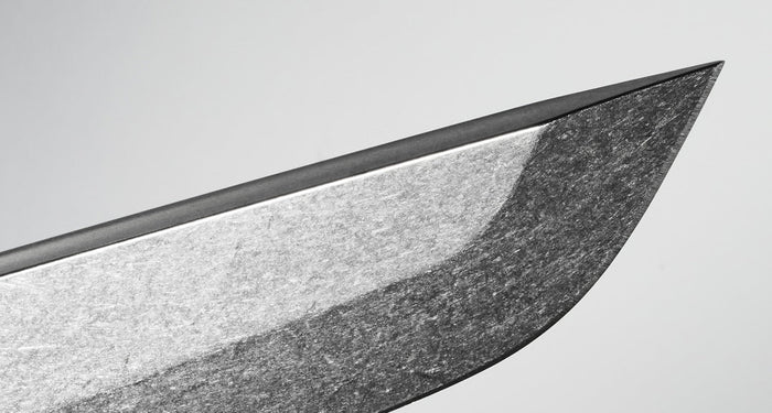 Translation missing: en.Close-up of a sharp knife blade showcasing its sleek, polished edge and metallic texture against a gray background