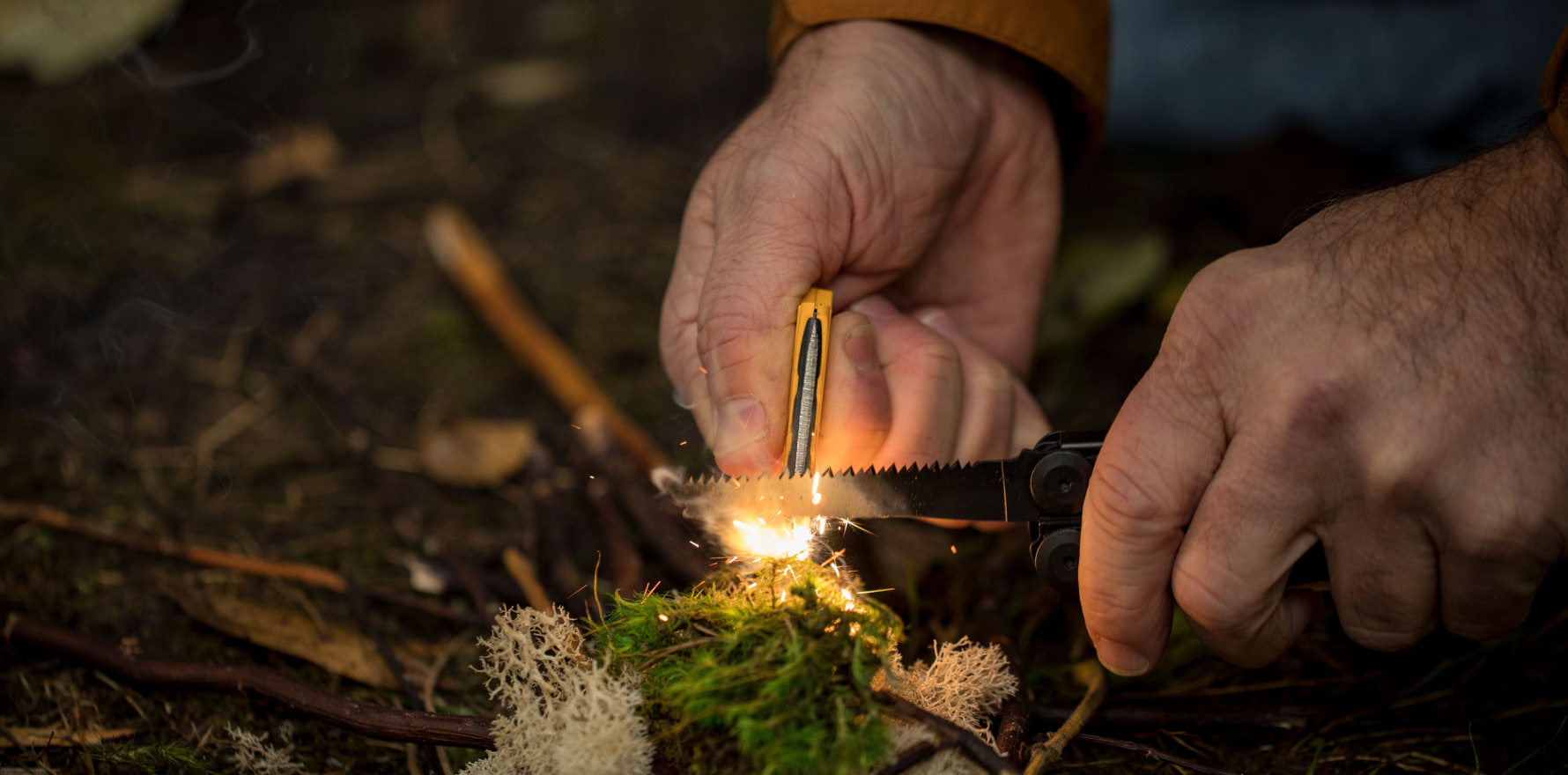 Signal ferro rod accessory being used on kindling