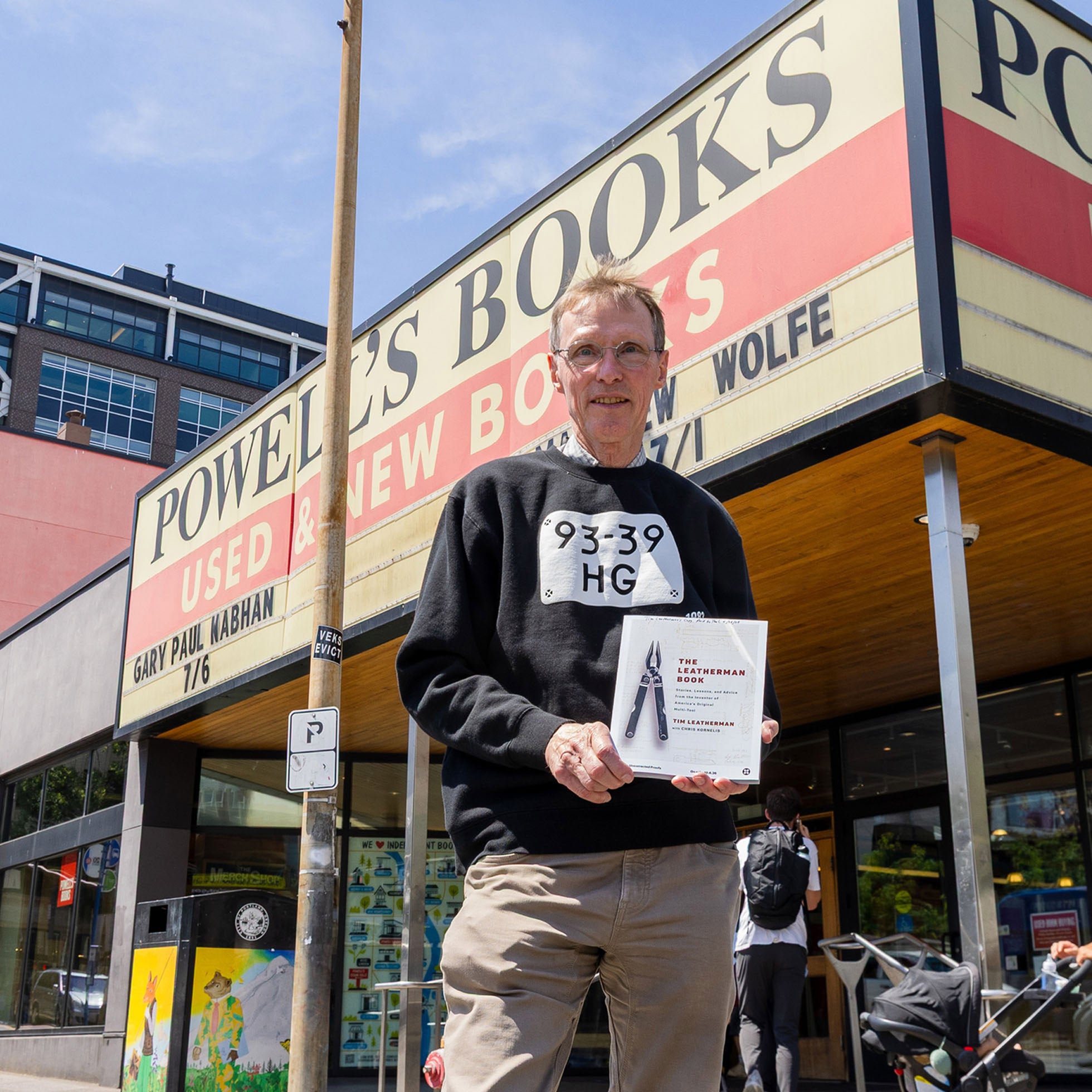Tim Leatherman holding The Leatherman Book outside Powell’s Books in Portland, Oregon